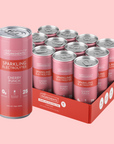 Pack of pink and red cans labeled "Just Ingredients Sparkling Electrolytes Cherry Punch" with 12 oz cans in a red cardboard b