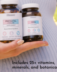 Two amber glass supplement bottles labeled "Prenatal + Choline" and "DHA" held in a hand against a striped white shirt.