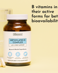 Brown glass bottle of Methylated B Complex with white label and white cap, with capsules visible beside it.
