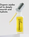Clear glass dropper bottle with yellow serum and a dropper, labeled "just INGREDIENTS."