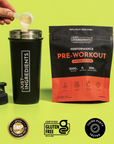 Hand pouring powder from black shaker cup next to black pouch labeled "Performance Pre-Workout Watermelon Lime" on yellow bac