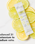 Electrolyte stick packet placed on sliced lemon and lime, featuring product details and a balanced potassium to sodium ratio.