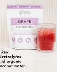 Purple packaging labeled "Grape Electrolytes" next to a glass of red liquid with ice.