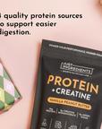 Black packaging of protein powder labeled "Protein + Creatine" in vanilla peanut butter flavor, with decorative gift wrapping