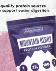 Purple protein powder bag with "Mountain Berry Protein Powder" label and a scoop icon, surrounded by loose powder.