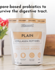 White pouch of Plain Collagen Peptides with tan label, displayed on counter with pink flowers and wooden box.