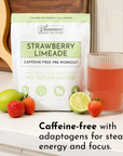 Caffeine-free pre-workout powder package next to a glass of strawberry limeade and fresh strawberries and lime.
