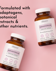 Two amber glass bottles with white caps labeled "Perimenopause Hormone Support" on pink background.