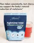 Dark blue pouch of strawberry limeade nighttime relax powder for kids next to a glass of red liquid.