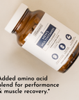 Brown glass bottle of men's multivitamin supplement with a white label and black text, partially tilted on a light surface.