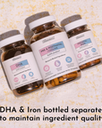 Three amber glass supplement bottles with white caps labeled DHA, Pre & Postnatal Choline, and Prenatal Iron on textured back