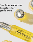 Yellow face serum bottle with a silver pump, labeled "just INGREDIENTS," on a white background.