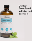 Brown glass bottle of Cool Mint Mouth Wash with a mint leaf beside it, labeled as dye-free and alcohol-free.