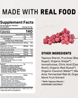 Red grapes next to supplement facts label listing nutrition information and other ingredients for endurance drink.