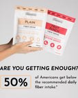 Two fiber drink packets held in hand: one labeled "Plain" and the other "Fruit Punch," both with 30 servings.