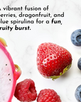 Dragonfruit, strawberry, raspberries, and blueberries arranged on a light marble background.