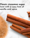 Cinnamon sticks and brown sugar on a marble surface.