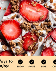 Sliced dessert bars topped with strawberries, granola, and chocolate chips on a light background.
