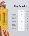 Hand holding bottle of body oil with label callouts listing key benefits and ingredient standards.