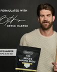 Person seated with Bryce's protein bag and a shaker bottle, holding a thoughtful pose.