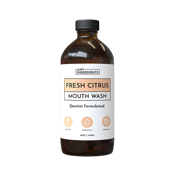 Brown glass 16 fl oz bottle of Fresh Citrus Remineralizing Mouthwash with white label — dentist-formulated.