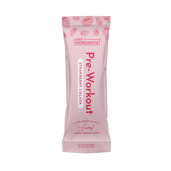 Pink single-serve pre-workout stick packet labeled "Strawberry Colada" with Just Ingredients and Lindsay Arnold branding on a white background