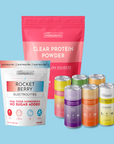 Just Ingredients clear protein powder and electrolyte products including pink powder pouch, rocket berry packet, and six colo