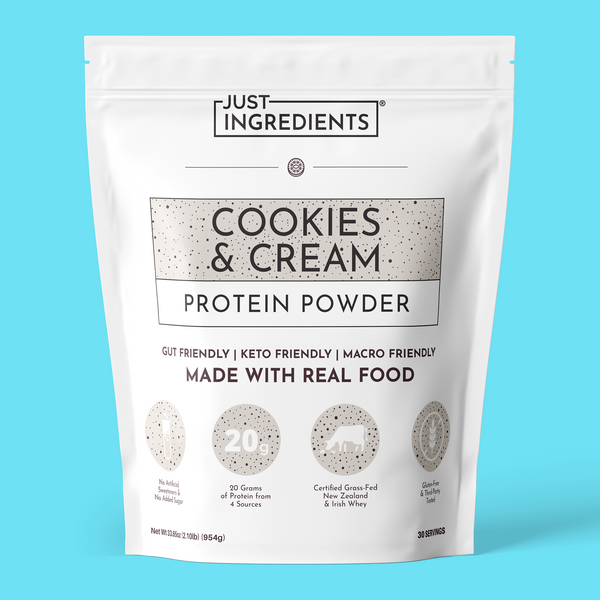 White pouch of Just Ingredients Cookies & Cream Protein Powder with speckled design and product details on light blue backgro