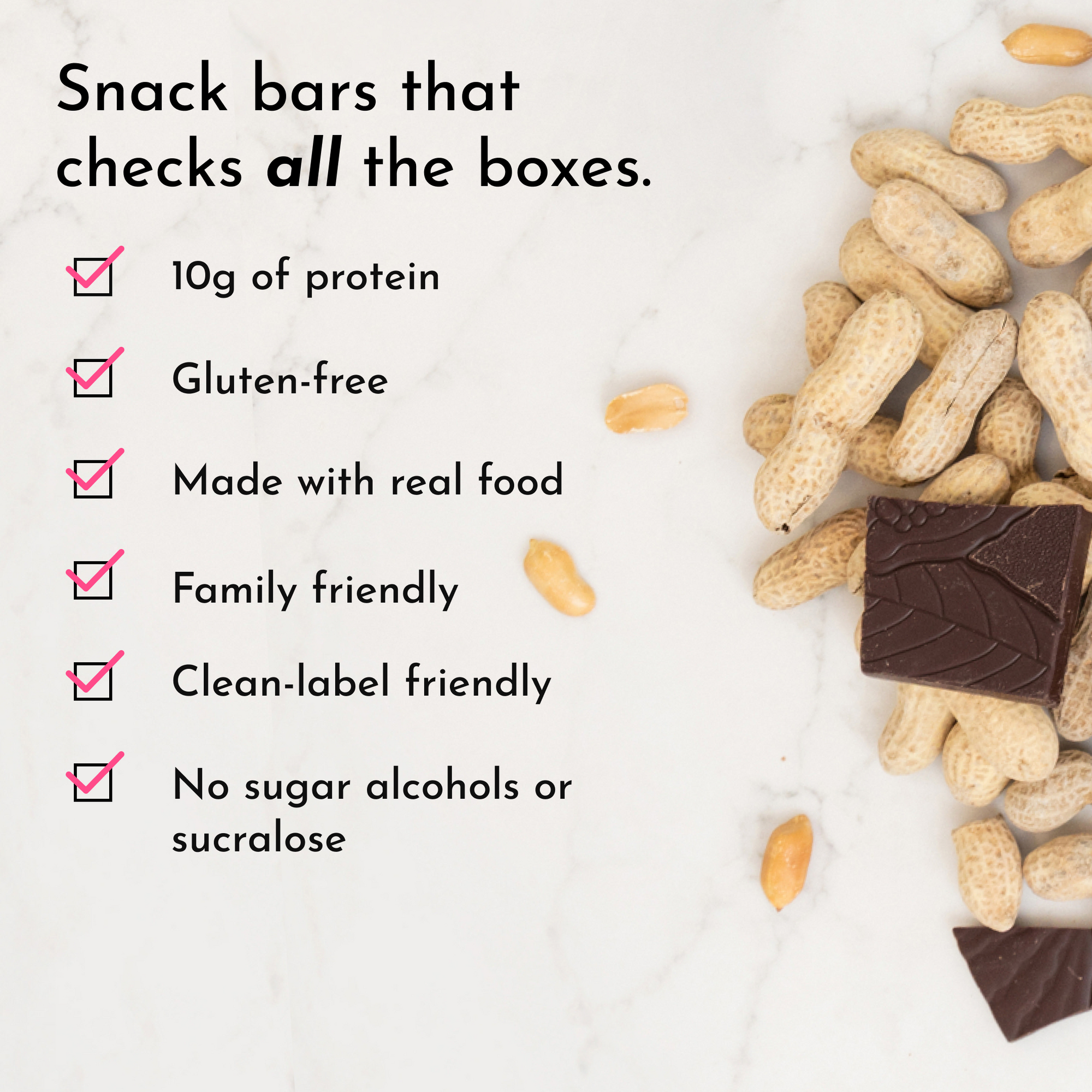 Peanut butter chocolate chip snack bar with peanuts and chocolate pieces on a marble surface.
