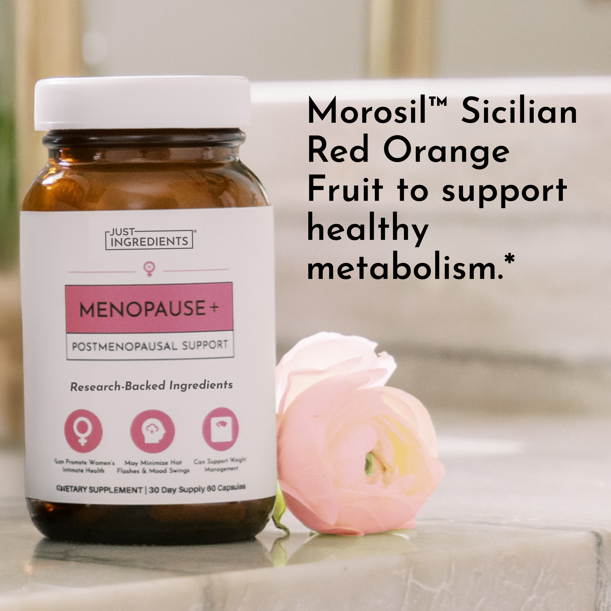 Amber glass bottle of Menopause+ postmenopausal support supplement with white cap, displayed next to a pink flower.
