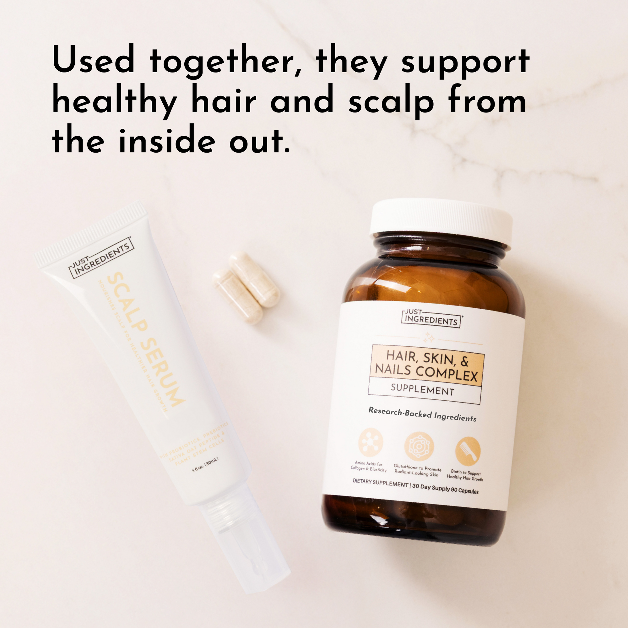 White scalp serum tube and amber supplement bottle labeled "Hair, Skin &amp; Nails Complex" on marble background.