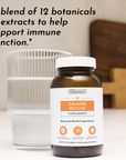Amber glass bottle of Immune Rescue supplement with white cap next to a ribbed glass of water on neutral background.