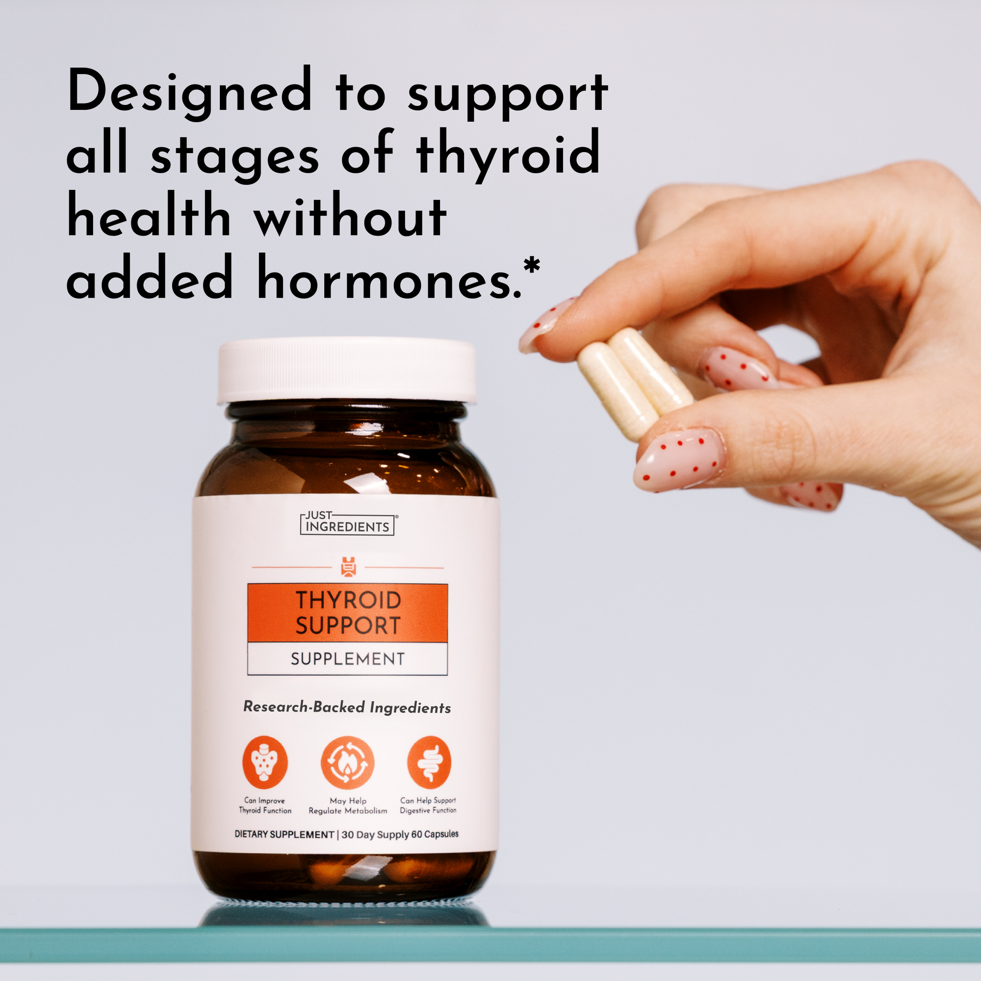 Hand holding brown glass bottle of Thyroid Support supplement with white label and orange accents.