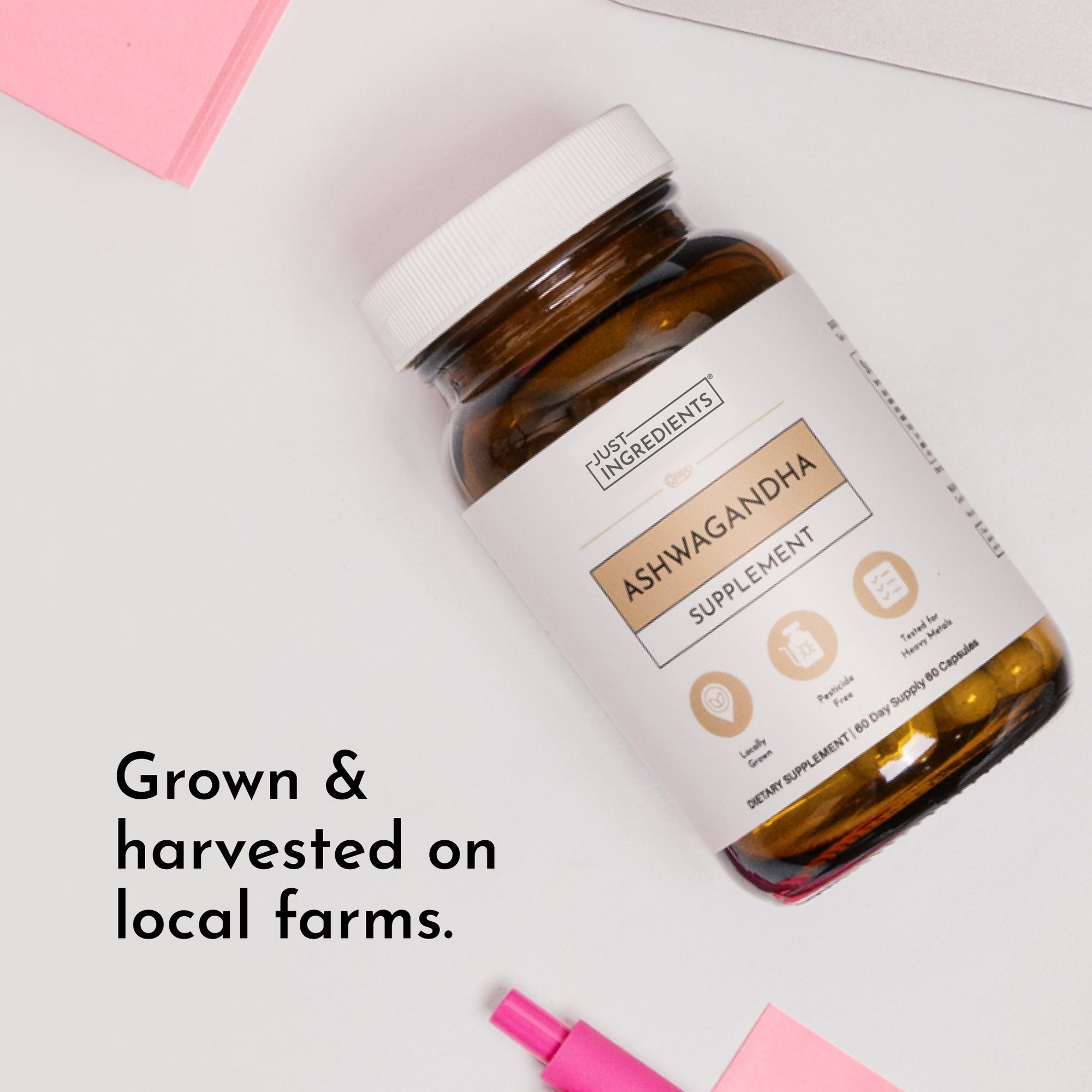 Brown glass bottle with white cap containing ashwagandha supplement capsules, labeled "Just Ingredients Ashwagandha Supplemen