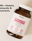 Brown bottle of women's multivitamin capsules with a white lid and a label detailing its contents and benefits.