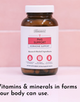 Dark amber glass bottle with white cap and label reading "PMS Support Hormone Support" against pink background.