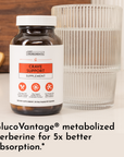 Dark glass supplement bottle with white cap labeled "Crave Support" next to a ridged cream-colored glass.