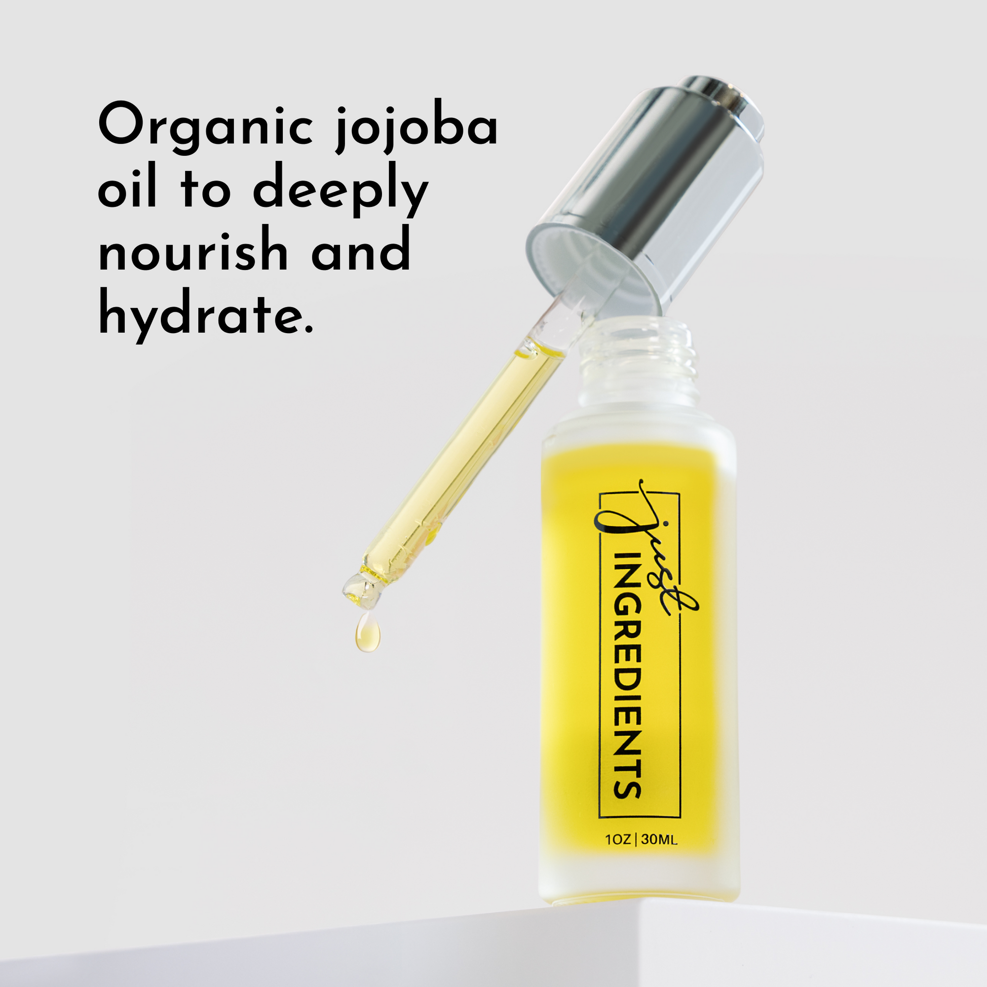 Clear glass dropper bottle with yellow serum and a dropper, labeled "just INGREDIENTS."