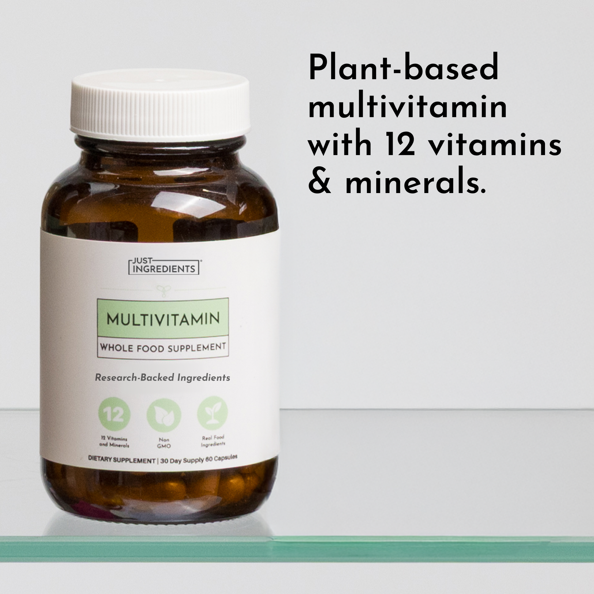 Brown glass bottle with white ridged cap containing multivitamin capsules, labeled "Just Ingredients Multivitamin Whole Food 