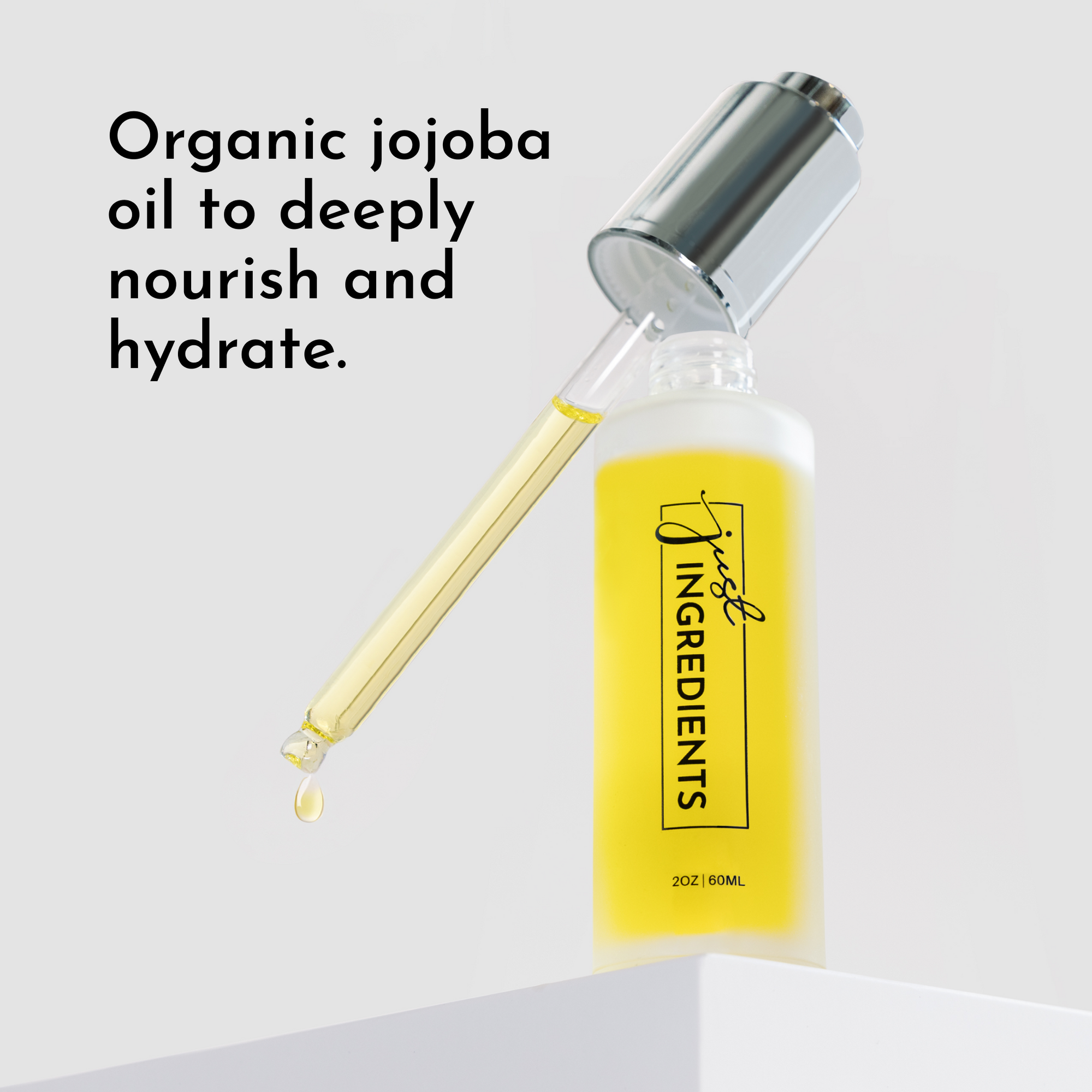 Clear glass dropper bottle with yellow serum and silver cap, featuring a dropper dispensing liquid.