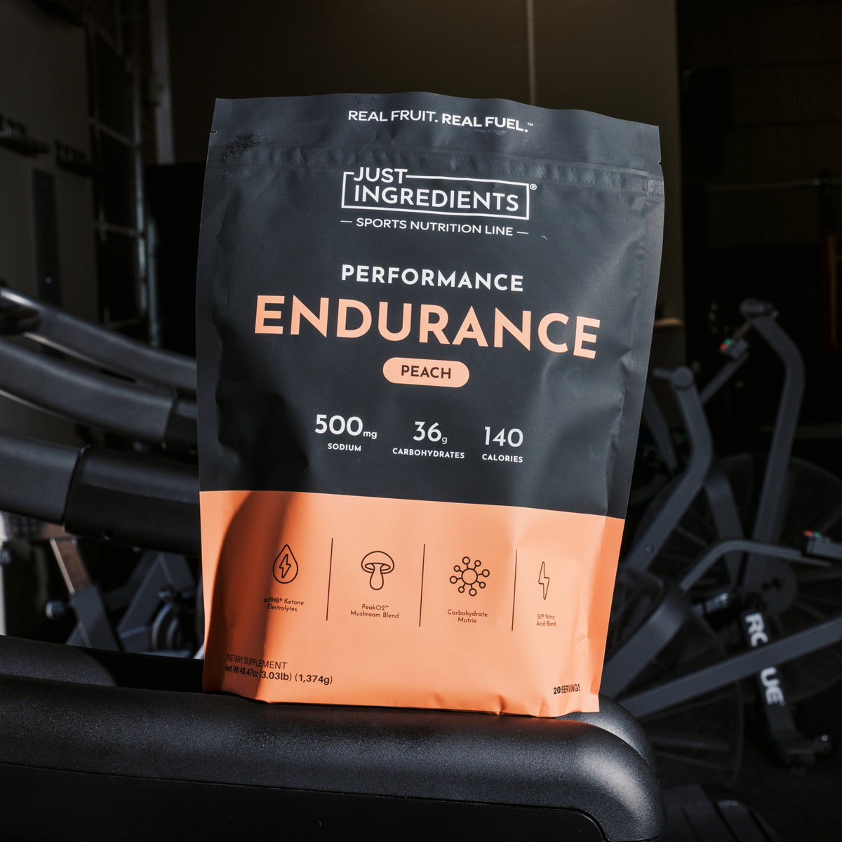 Black and peach pouch of Just Ingredients Performance Endurance drink mix with nutrition information displayed, sitting on ex