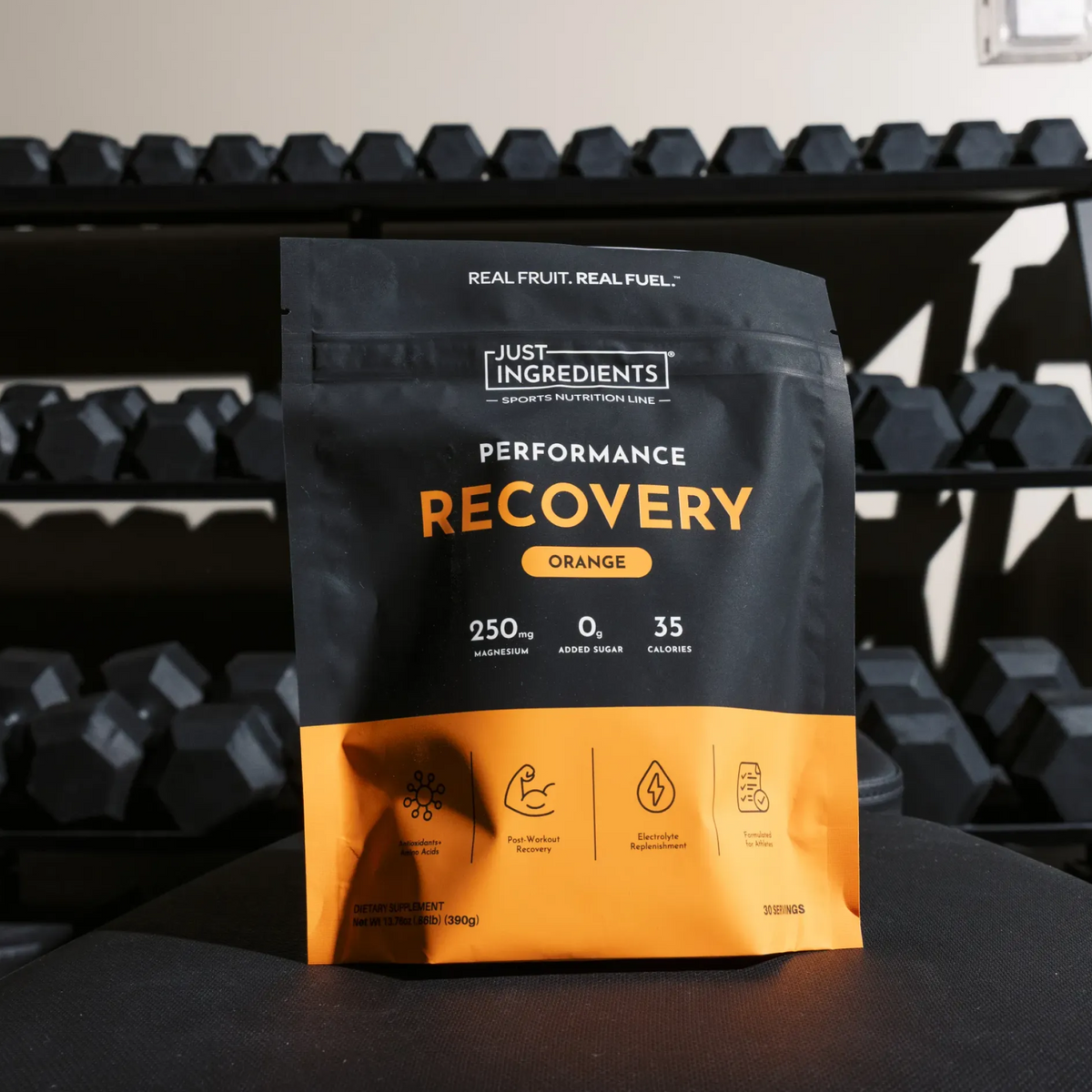Black and orange pouch of Just Ingredients Performance Recovery drink in orange flavor with nutrition facts and benefit icons