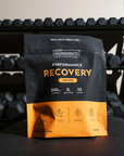 Black and orange pouch of Just Ingredients Performance Recovery drink in orange flavor with nutrition facts and benefit icons