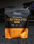 Black and orange pouch of Just Ingredients Performance Electrolytes in orange flavor with nutrition information and ingredien