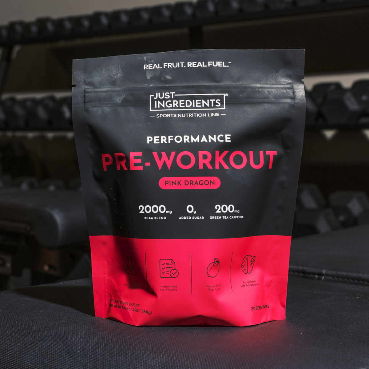 Black and red pouch of Just Ingredients Pink Dragon Performance Pre-Workout with specs for BCAA blend, zero sugar, and green 