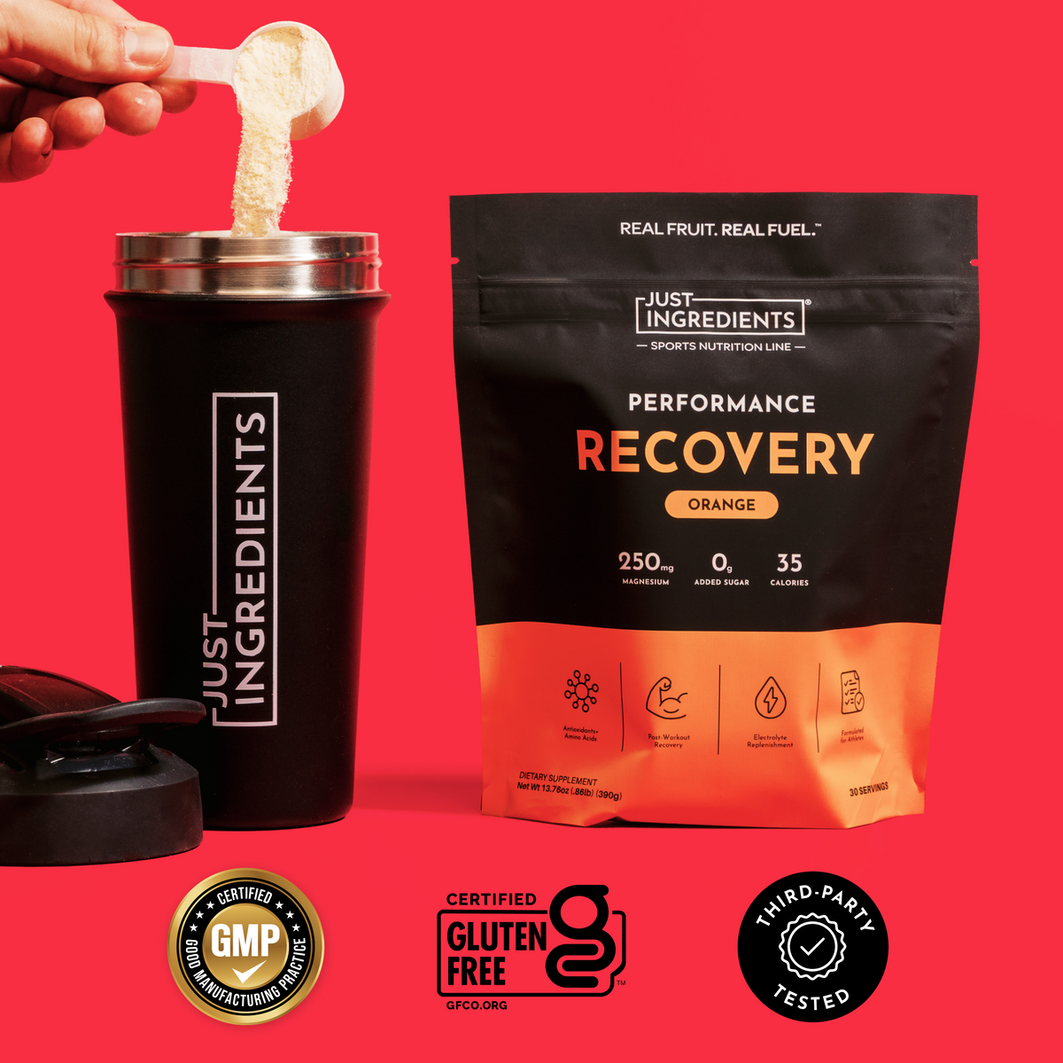 Orange-flavored recovery drink powder in black pouch with black shaker cup, shown being mixed against red background.