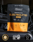 Black and orange pouch of Performance Electrolytes in orange flavor with nutrition information and certification badges displ