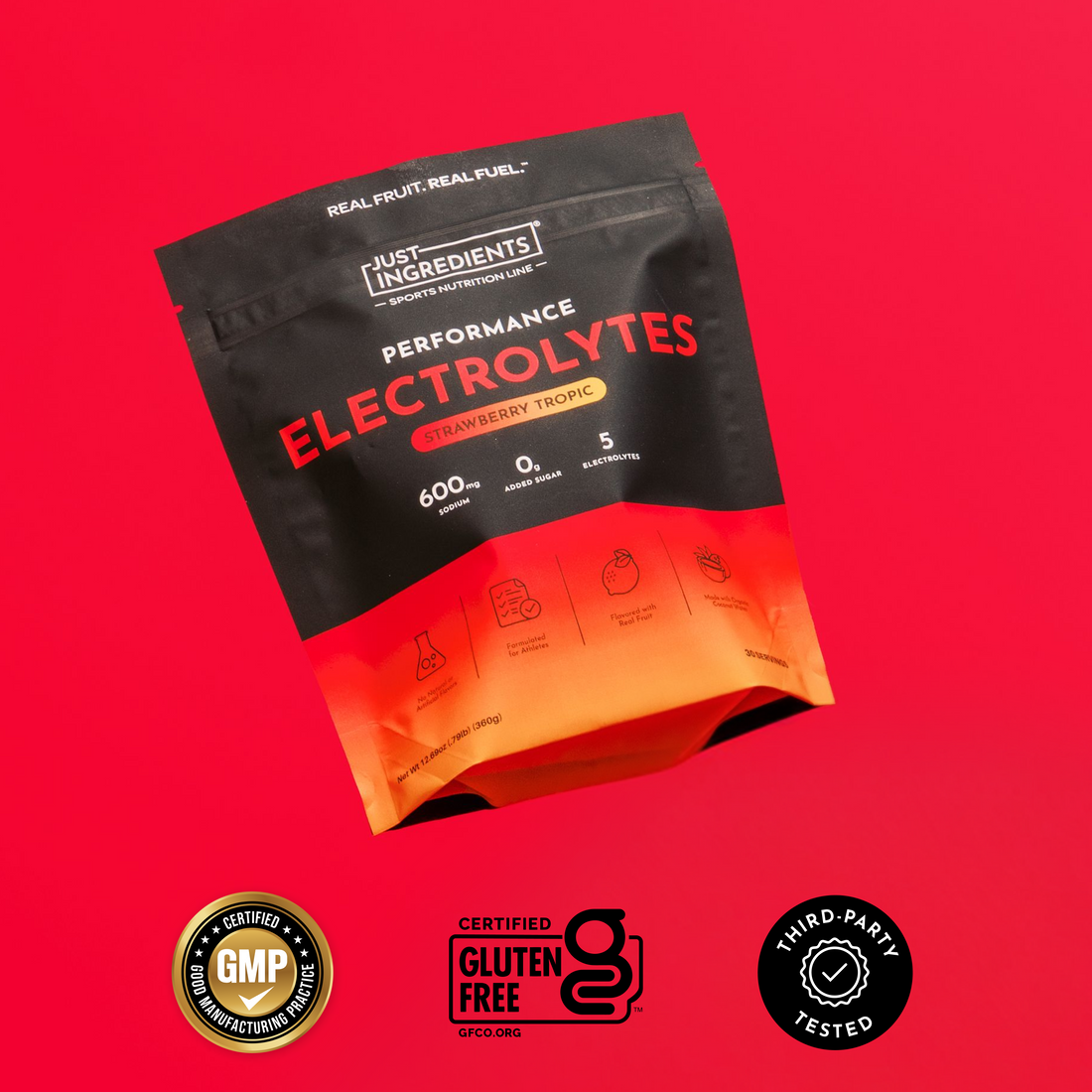 Black and orange electrolyte powder packets labeled "Strawberry Tropic" with "Just Ingredients" branding on red background.