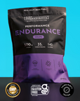 Black and purple pouch of grape-flavored endurance drink with nutrition information and certification badges on blue backgrou