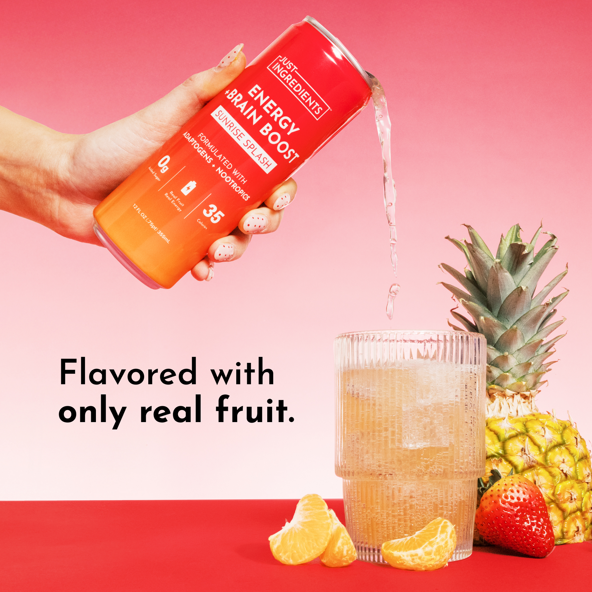 A hand pours a drink from a can into a glass, surrounded by fruit and a pineapple on a colorful background.